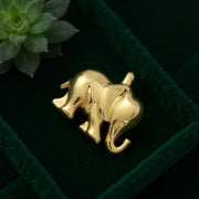 18K yellow gold elephant-shaped pendant symbolizing fortune and elegance in a green velvet box